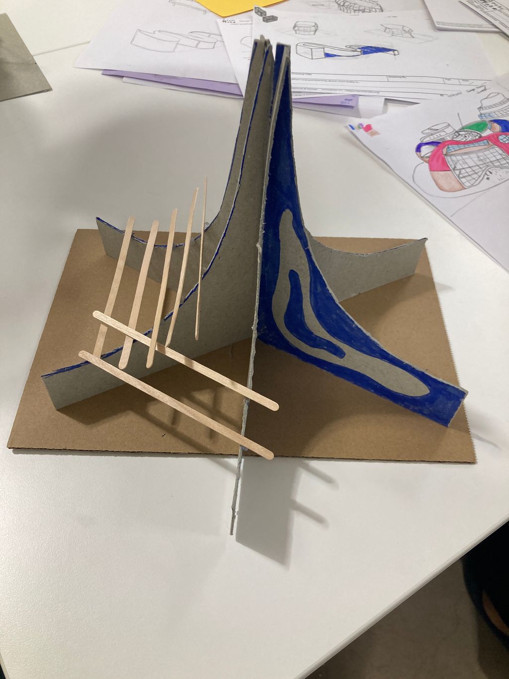 A student architecture model made of card and wooden sticks